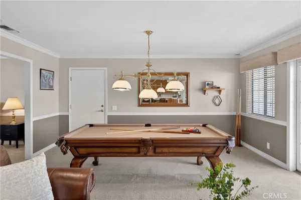 a living room with furniture pool table and view of living room