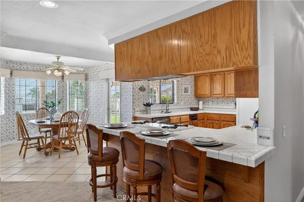 a dining room with a sink a counter top space and furniture