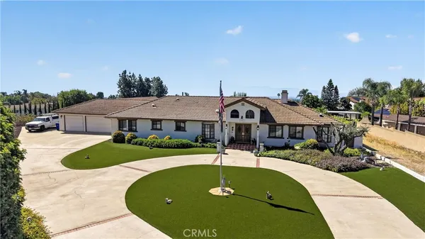 a view of a house with swimming pool and yard