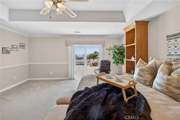 a spacious bedroom with a bed and a chair