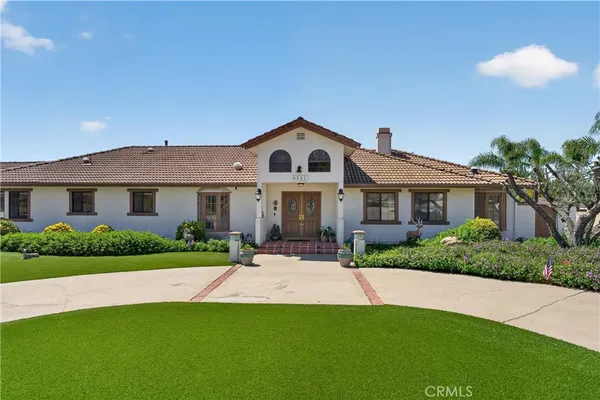 a front view of a house with a yard and porch
