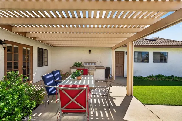 a view of a house with a porch and sitting area