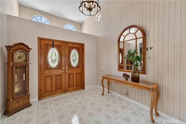 a living room with furniture a large window and a fireplace