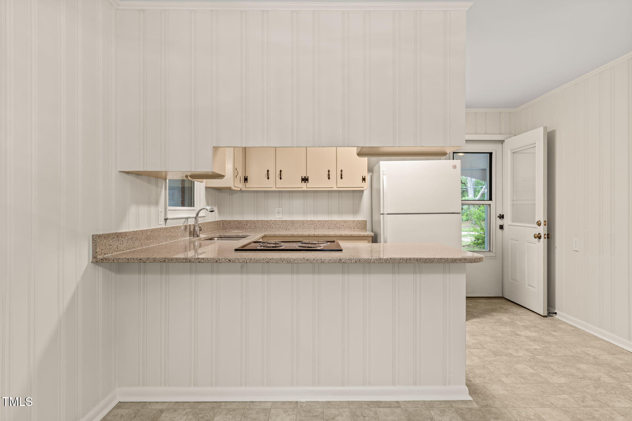 413 Winterlochen Road Raleigh, NC 27603 - Photo 10 of 44 a kitchen with a sink a stove and a refrigerator