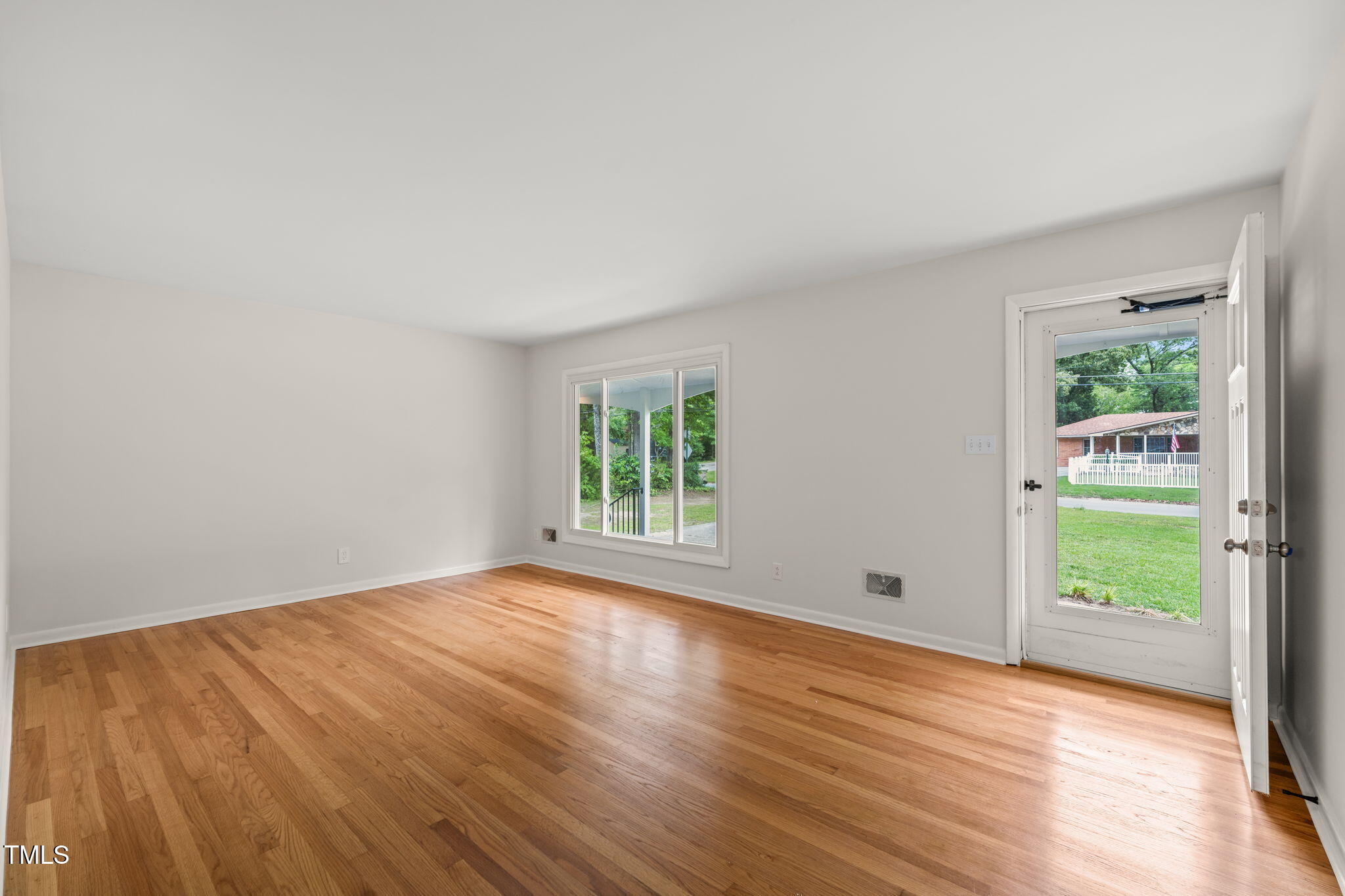 413 Winterlochen Road Raleigh, NC 27603 - Photo 13 of 44 a view of an empty room with wooden floor and a window