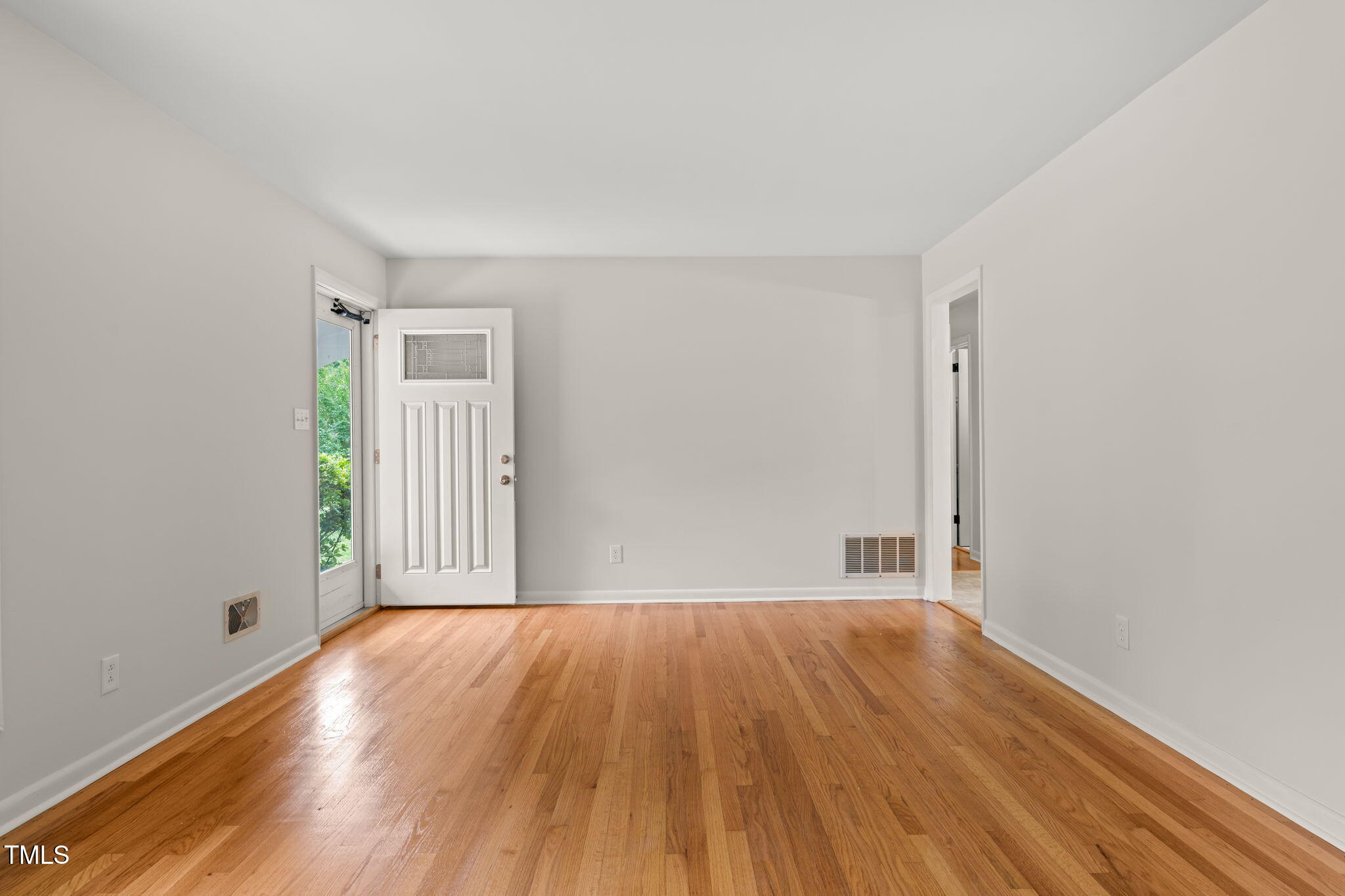 413 Winterlochen Road Raleigh, NC 27603 - Photo 14 of 44 a view of a big room with wooden floor and windows
