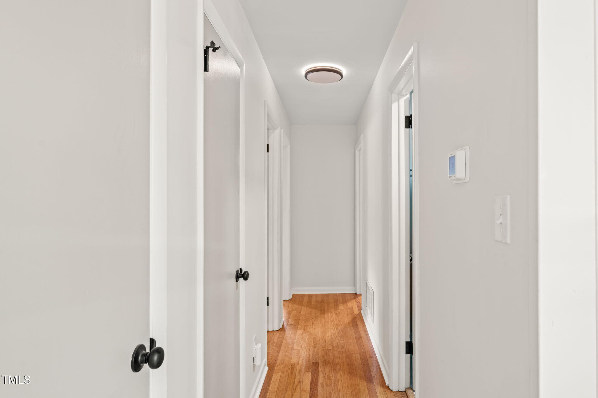 413 Winterlochen Road Raleigh, NC 27603 - Photo 15 of 44 a view of a hallway with wooden floor