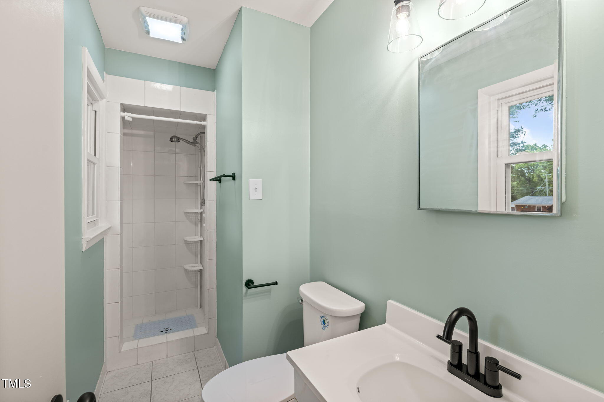 413 Winterlochen Road Raleigh, NC 27603 - Photo 16 of 44 a bathroom with a toilet sink and shower