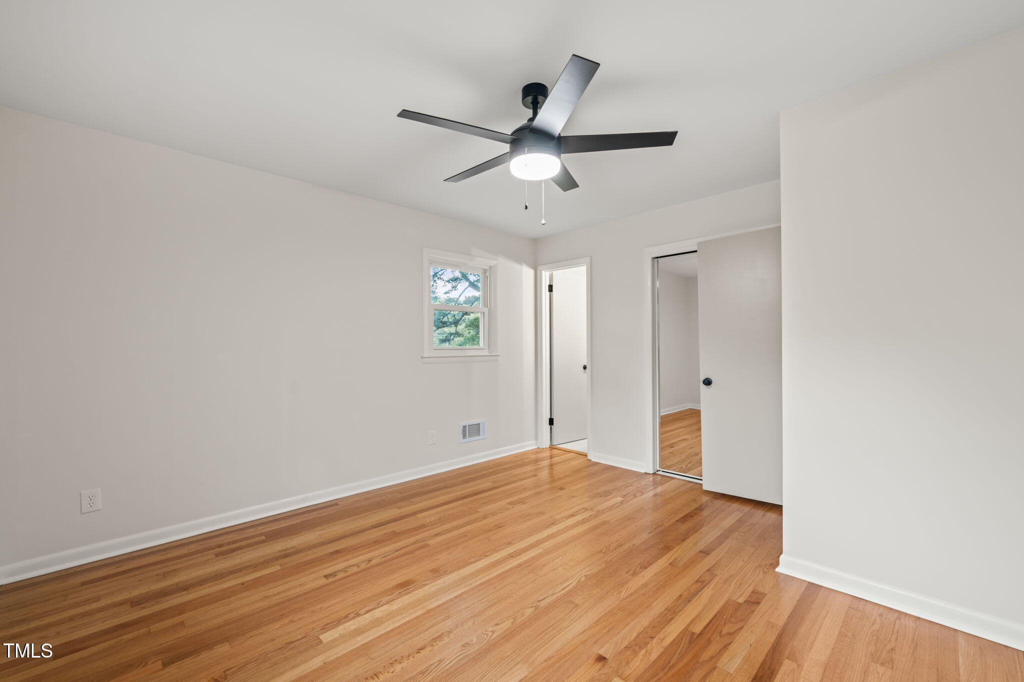 413 Winterlochen Road Raleigh, NC 27603 - Photo 17 of 44 a view of an empty room with wooden floor
