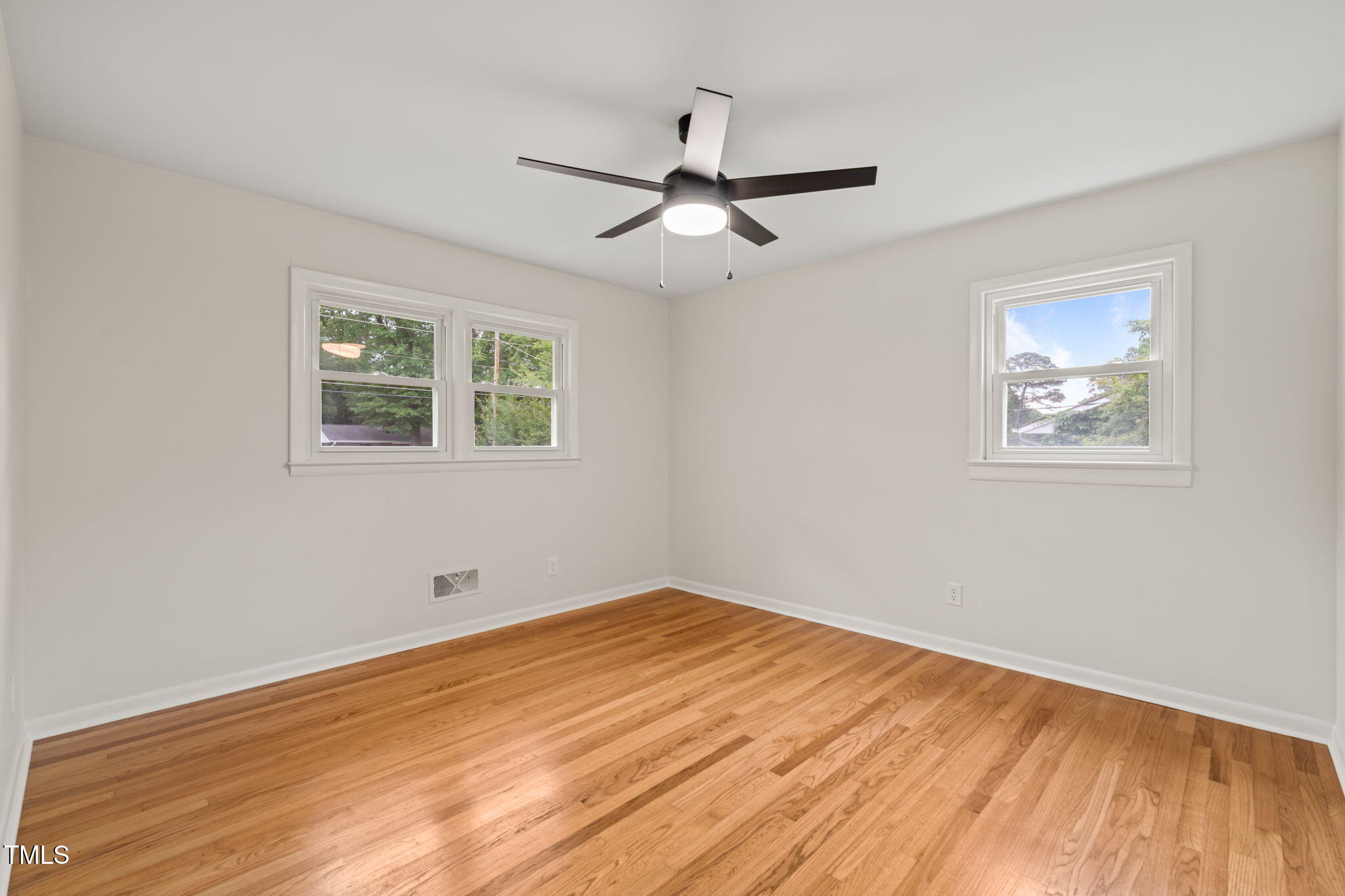 413 Winterlochen Road Raleigh, NC 27603 - Photo 18 of 44 a view of empty room with wooden floor