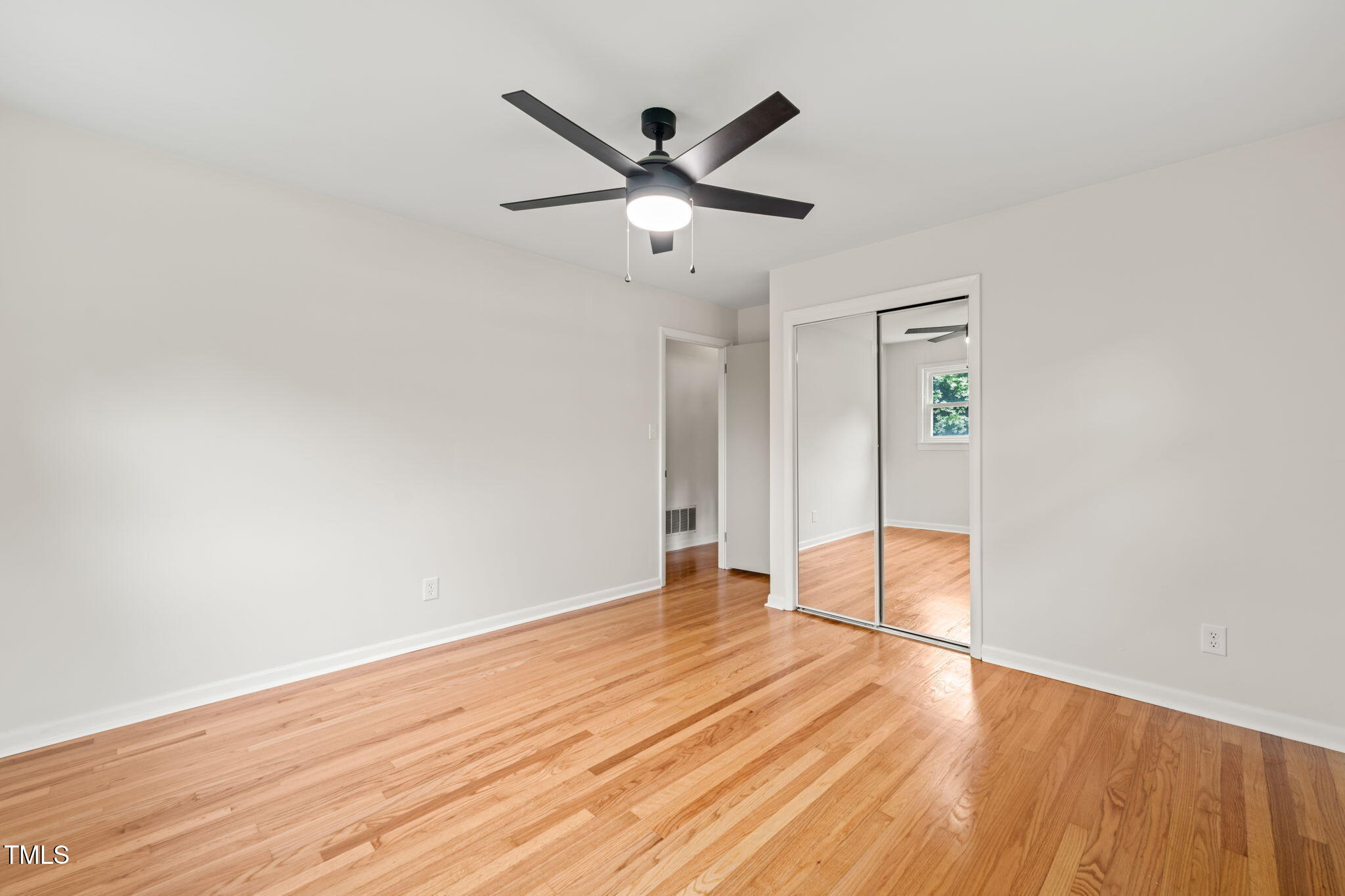 413 Winterlochen Road Raleigh, NC 27603 - Photo 19 of 44 a view of empty room with wooden floor
