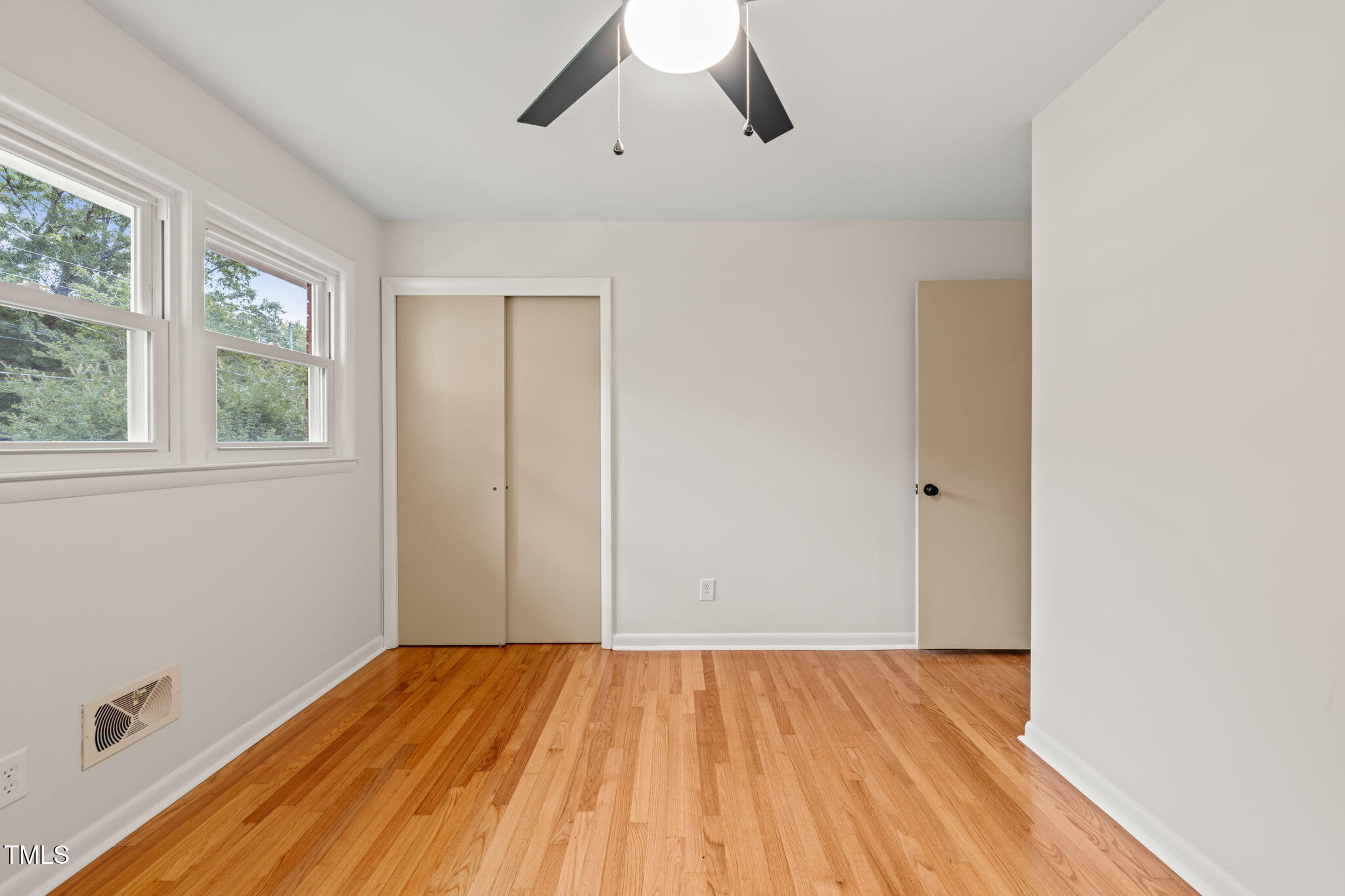 413 Winterlochen Road Raleigh, NC 27603 - Photo 20 of 44 an empty room with a hardwood and ceiling fan