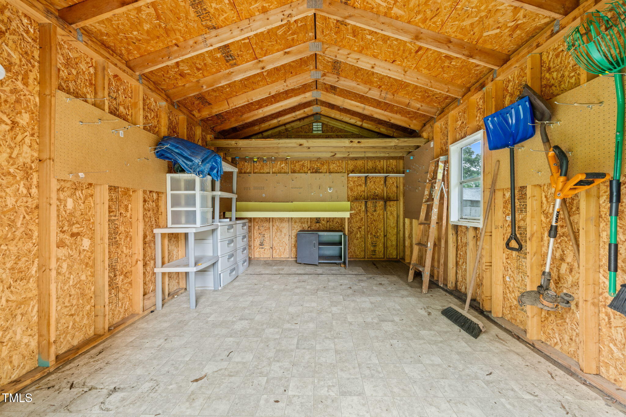 413 Winterlochen Road Raleigh, NC 27603 - Photo 25 of 44 a view of a big room with wooden walls and windows