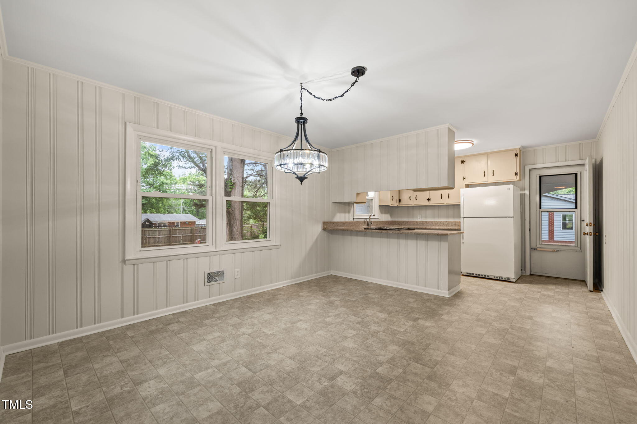413 Winterlochen Road Raleigh, NC 27603 - Photo 3 of 44 a kitchen with refrigerator and window