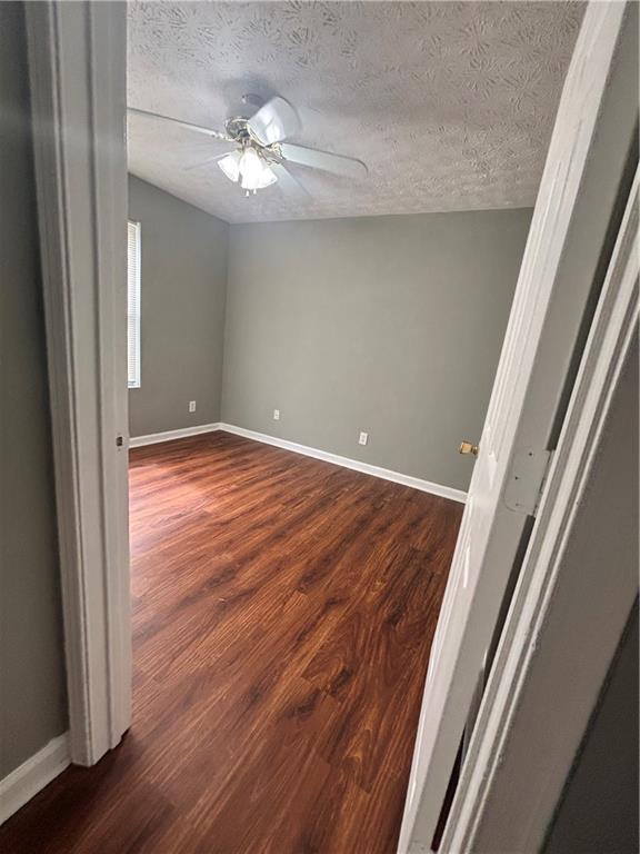 3101 Par 3 Way Lithonia, GA 30038 - Photo 23 of 32 a view of an empty room with wooden floor and a window