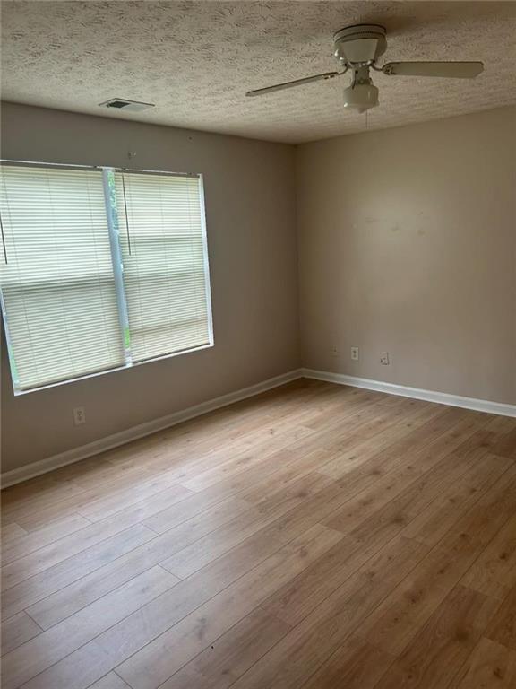 3101 Par 3 Way Lithonia, GA 30038 - Photo 5 of 32 an empty room with wooden floor and windows