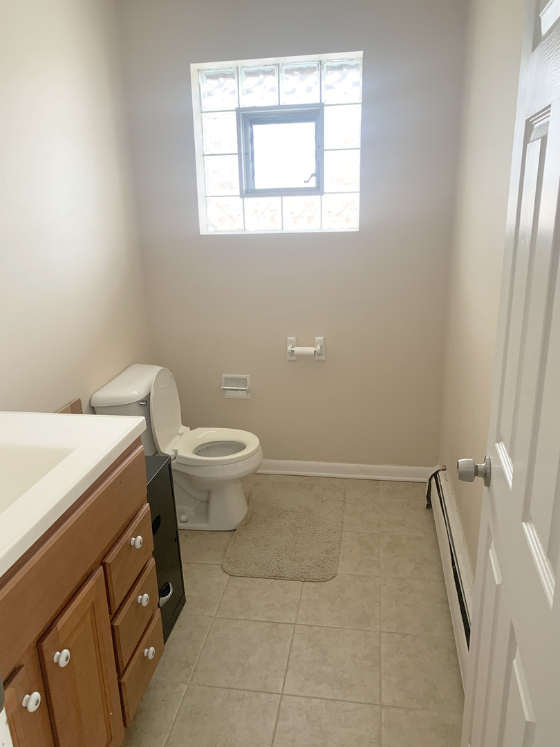 416 South Summit Street, Unit 2 Barrington, IL 60010 - Photo 6 of 13 a bathroom with a toilet sink and window