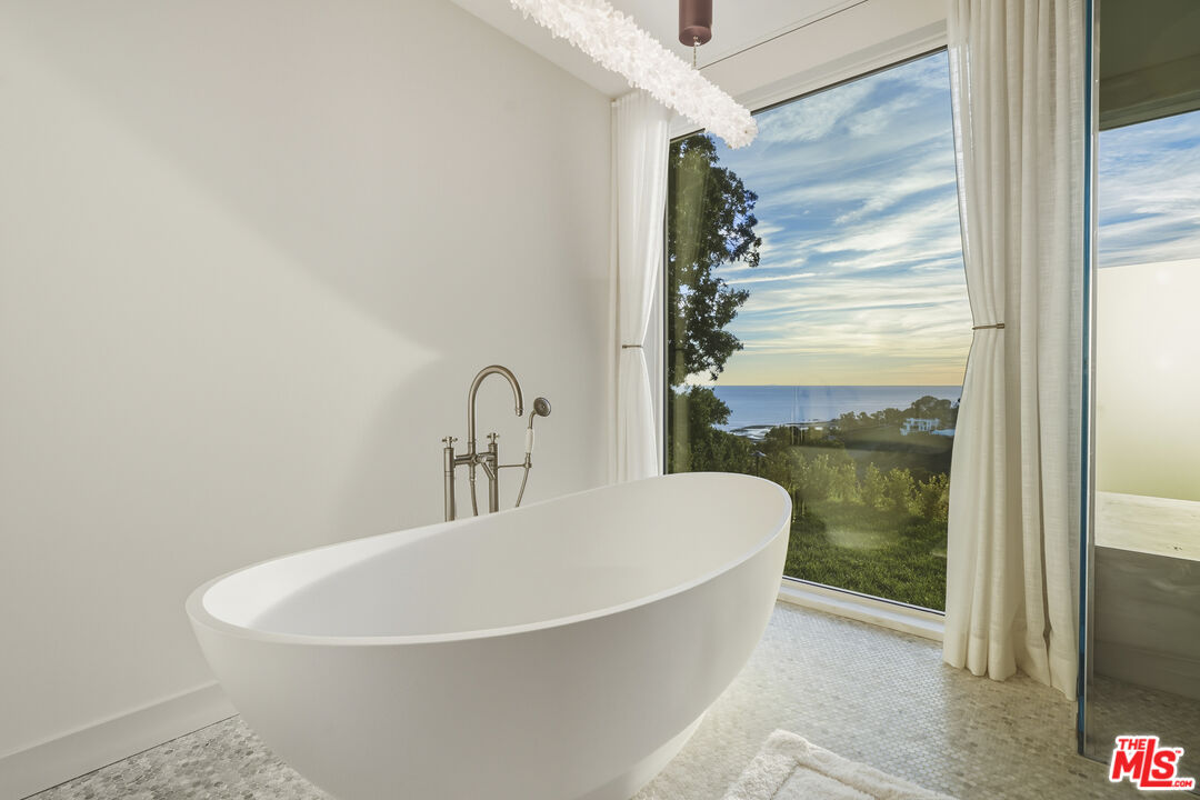 3140 Sweetwater Mesa Road Malibu, CA 90265 - Photo 44 of 71 a white bath tub sitting in a bathroom