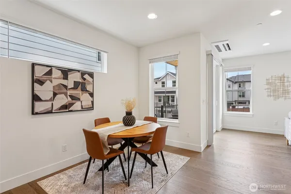 a view of a dining room with furniture and wooden floor