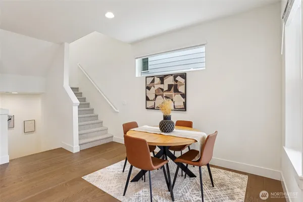 a dining room with furniture and wooden floor