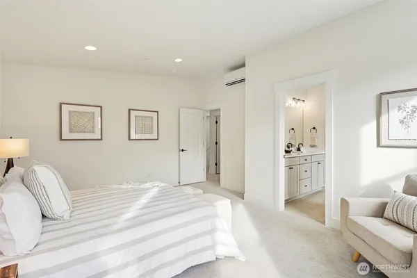 a spacious bedroom with a bed and a couch