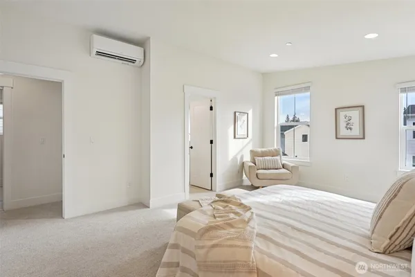 a bedroom with a bed and white cabinets