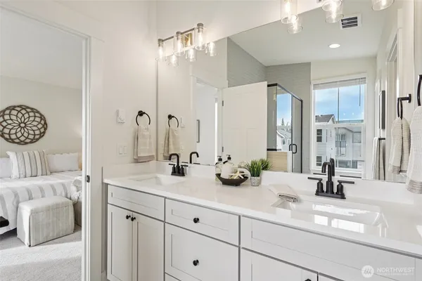 a bathroom with a double vanity sink mirror and