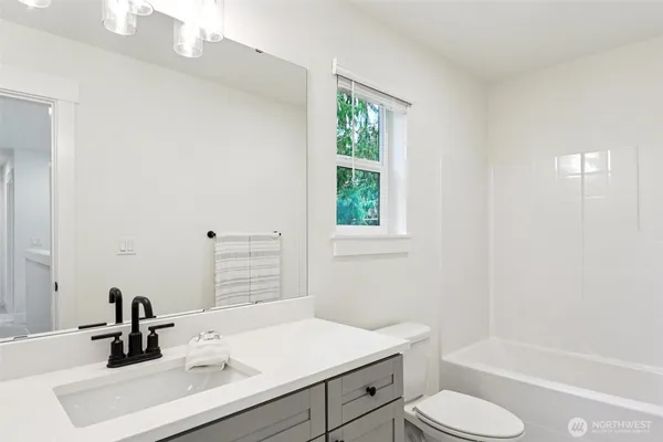 a bathroom with a sink toilet tub and shower