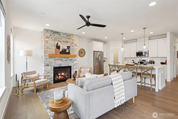 a living room with furniture fireplace and dining table
