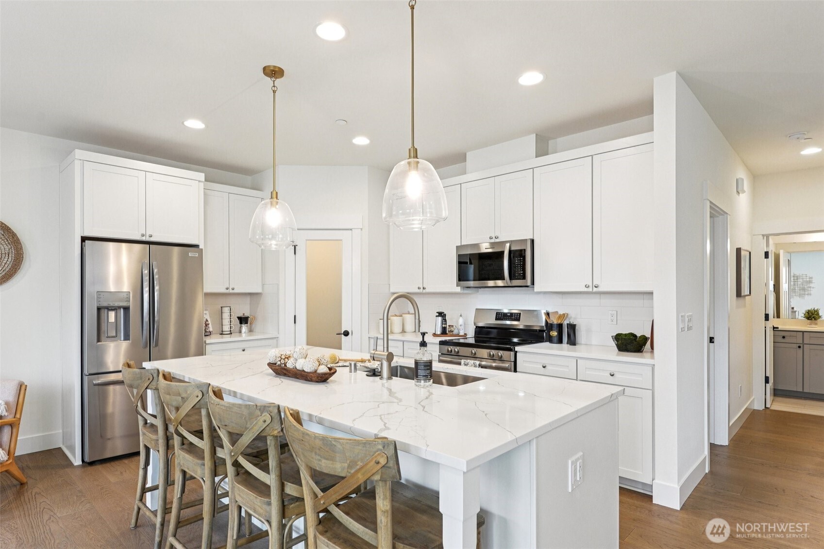 11 160th Place Southeast Bothell, WA 98012 - Photo 7 of 39 a kitchen with stainless steel appliances kitchen island granite countertop a sink a refrigerator a center island a stove and a cabinets