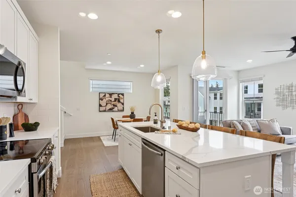 a kitchen with a sink appliances and cabinets