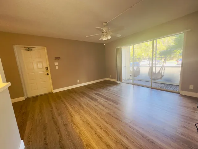 wooden floor in an empty room with a window