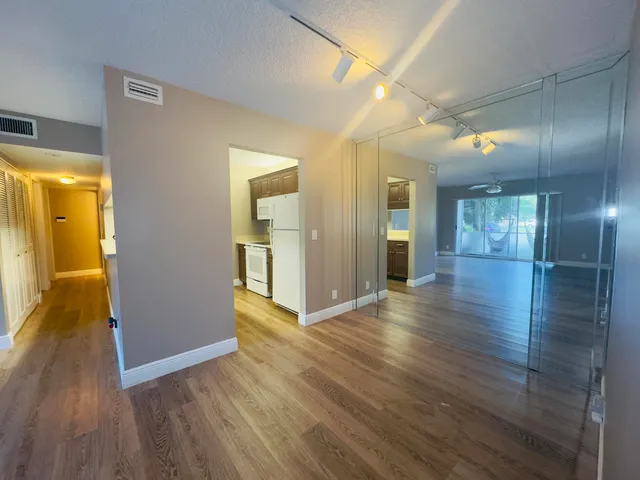 a view of hallway with wooden floor