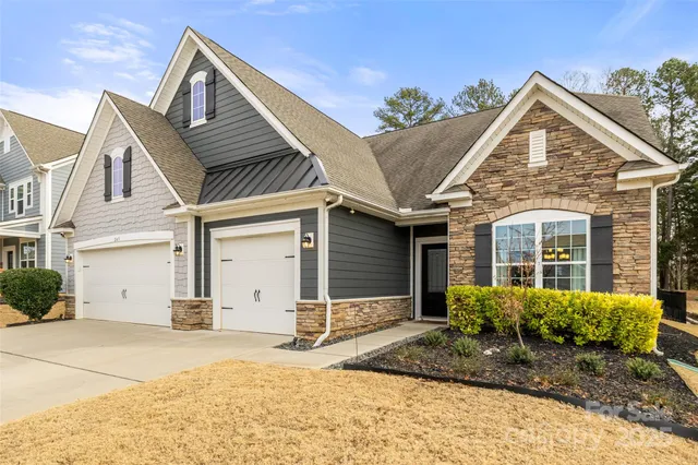 a view of a house with a yard and garage