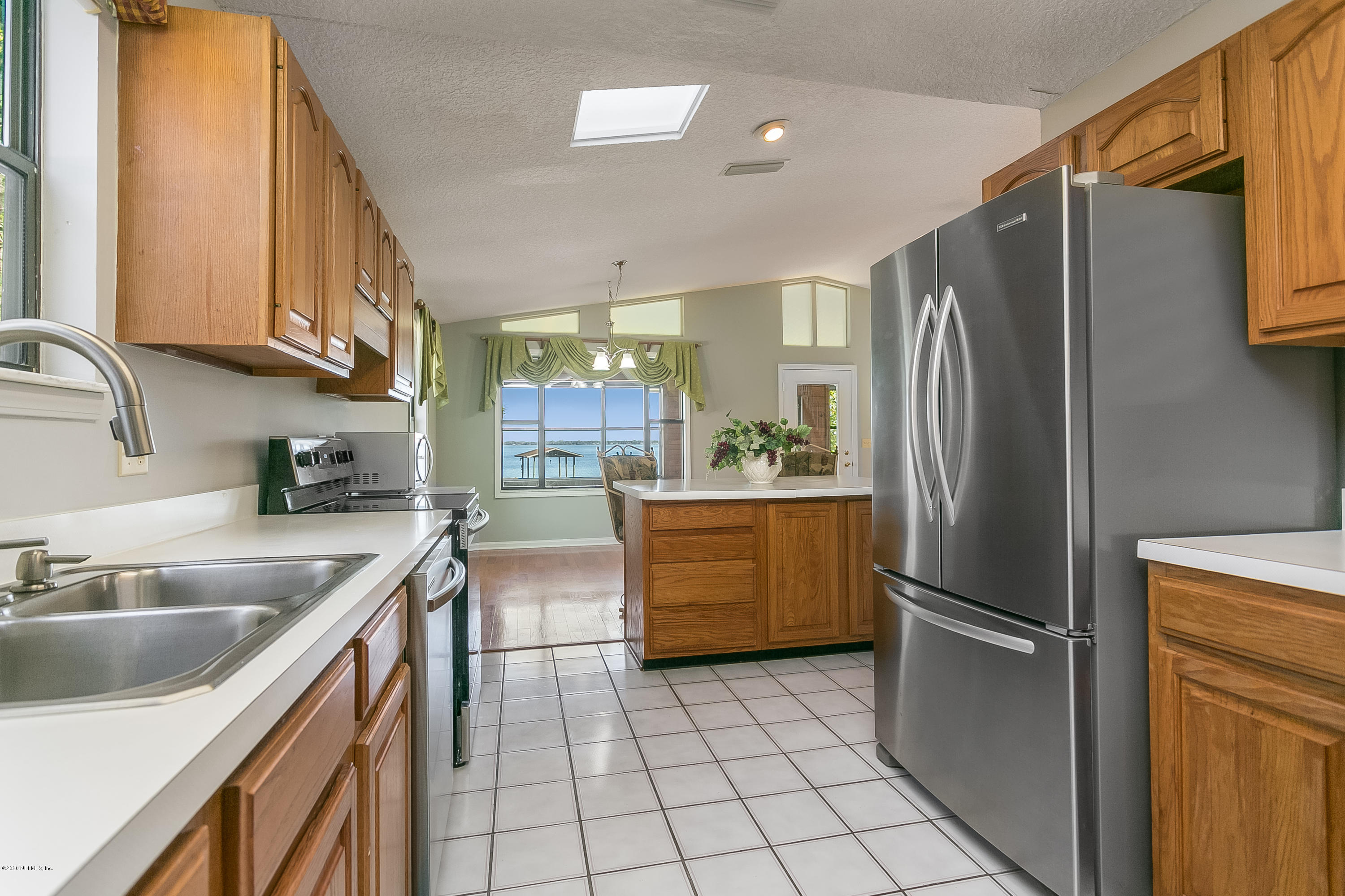 4239 Magnolia Road Orange Park, FL 32065 - Photo 12 of 40 a kitchen with a sink cabinets and stainless steel appliances