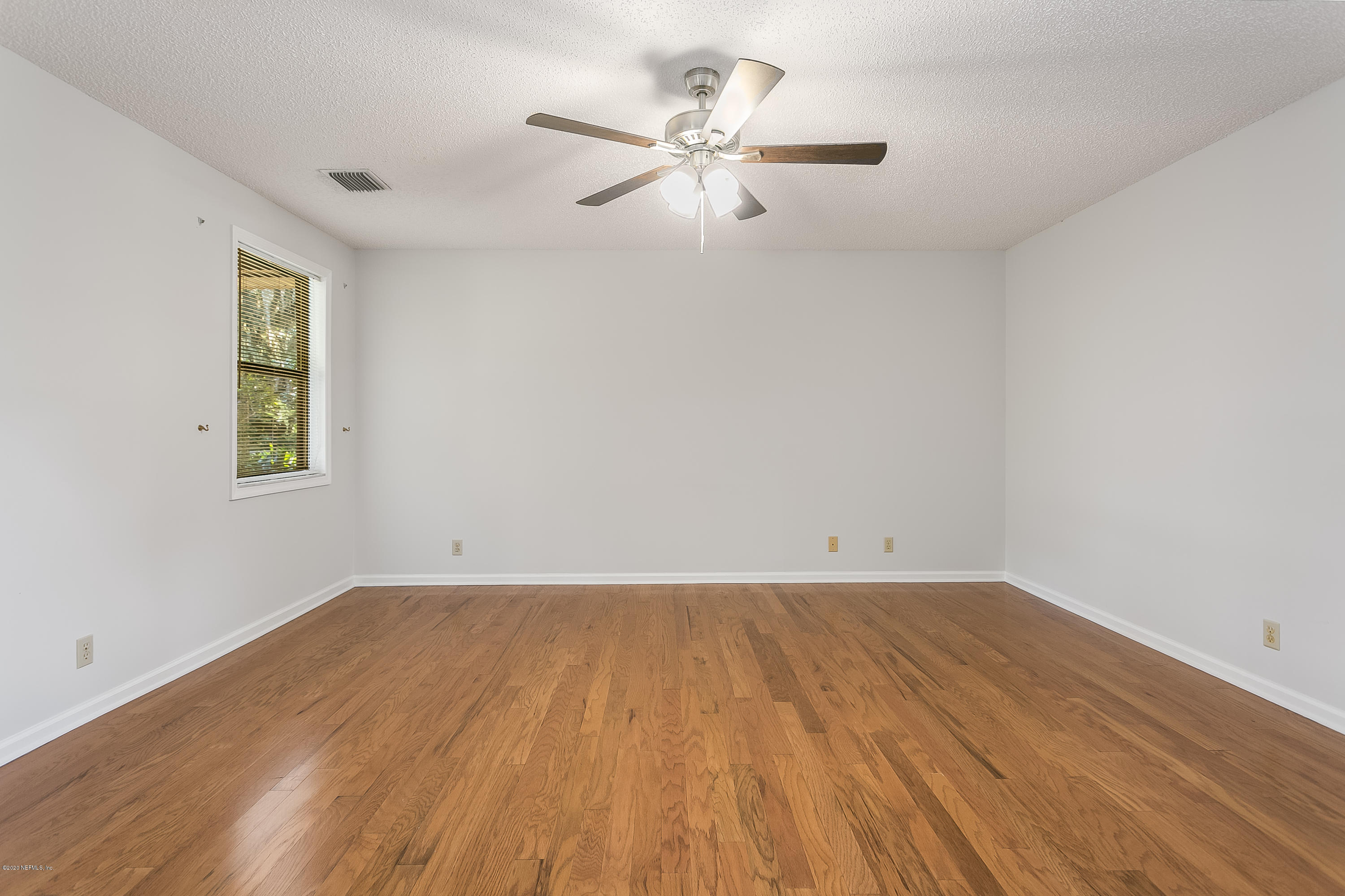 4239 Magnolia Road Orange Park, FL 32065 - Photo 19 of 40 an empty room with wooden floor and windows