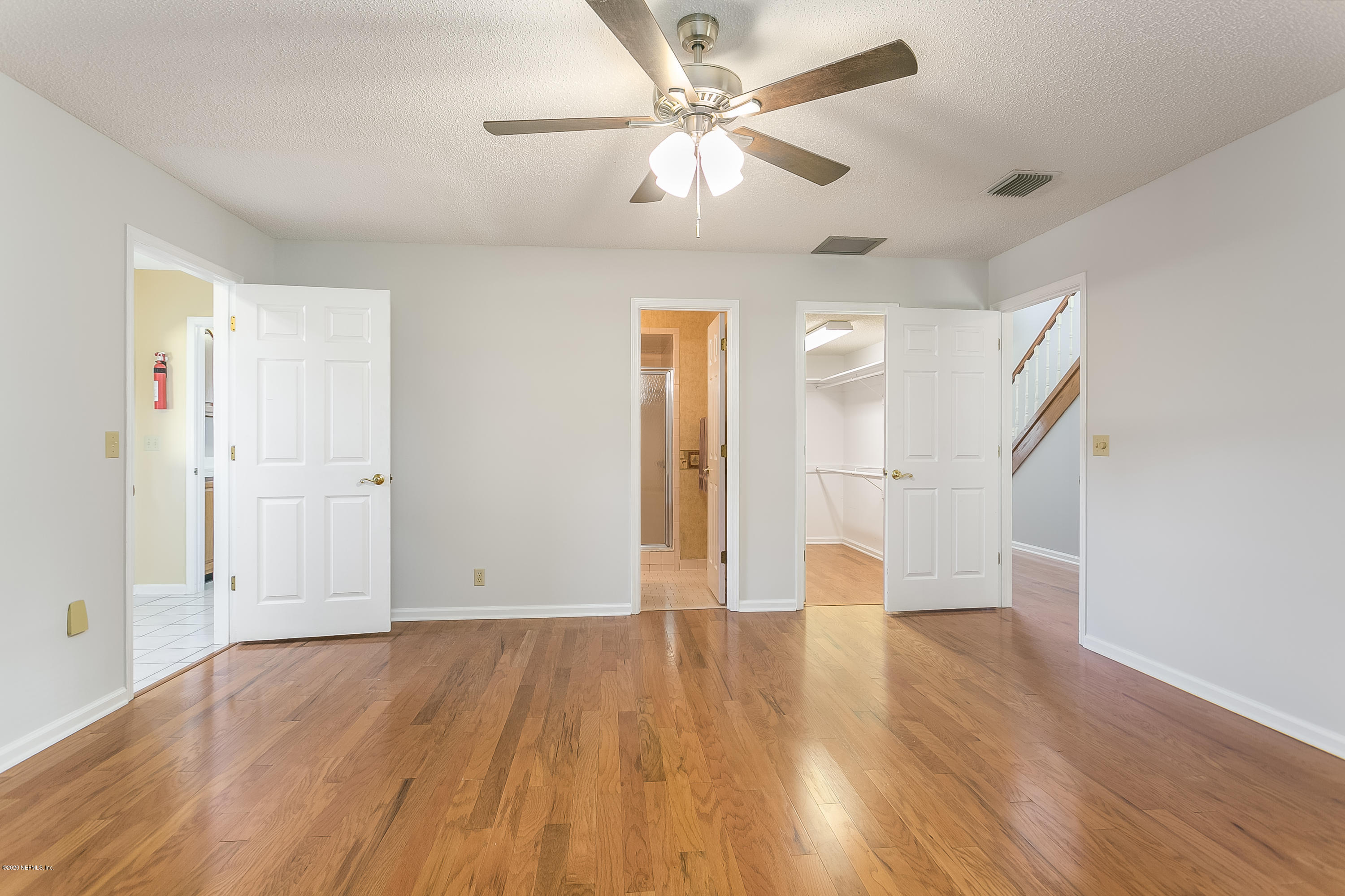4239 Magnolia Road Orange Park, FL 32065 - Photo 21 of 40 a view of an empty room with wooden floor and a ceiling fan