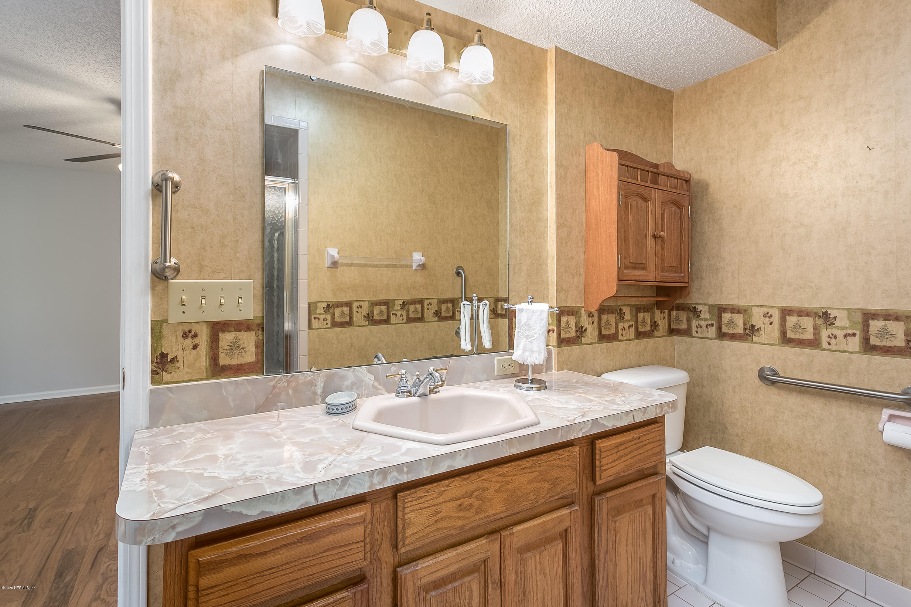 4239 Magnolia Road Orange Park, FL 32065 - Photo 22 of 40 a bathroom with a sink and a mirror