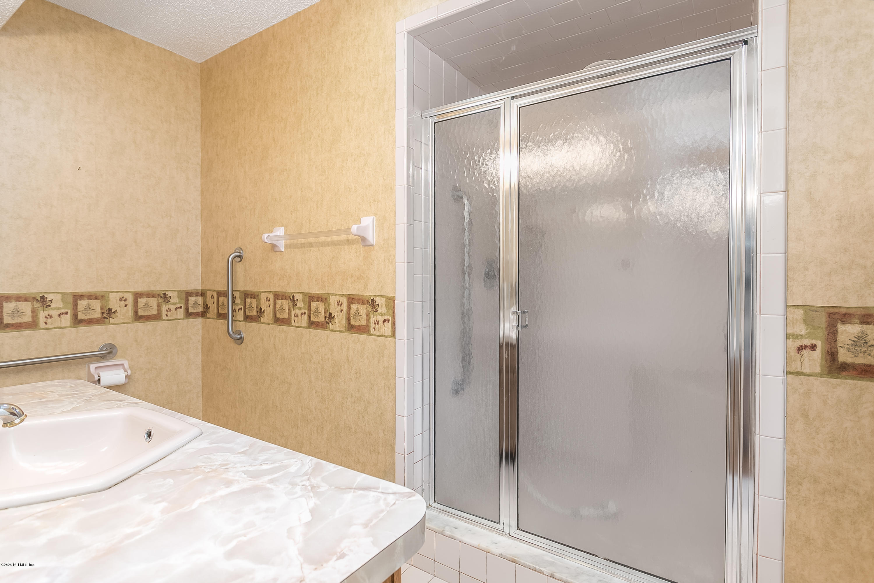 4239 Magnolia Road Orange Park, FL 32065 - Photo 23 of 40 a bathroom with a bathtub and shower