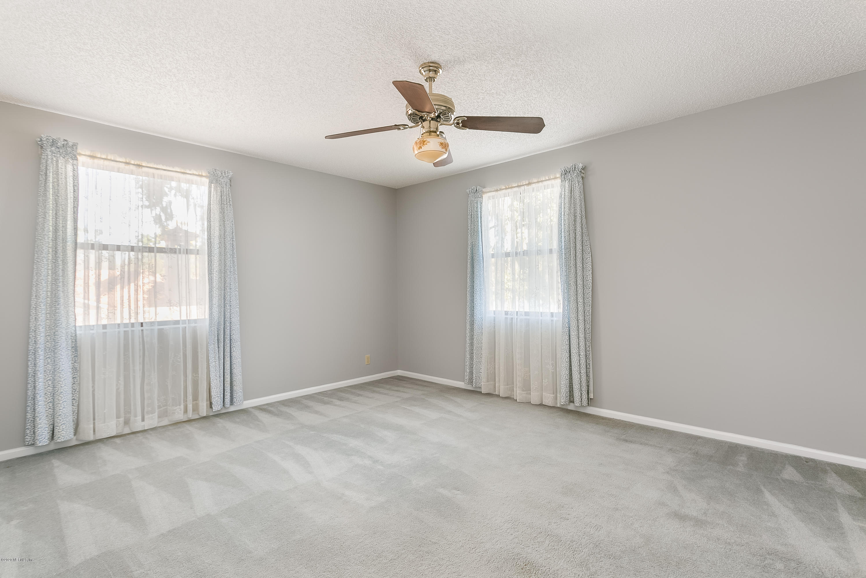 4239 Magnolia Road Orange Park, FL 32065 - Photo 26 of 40 an empty room with windows and fan