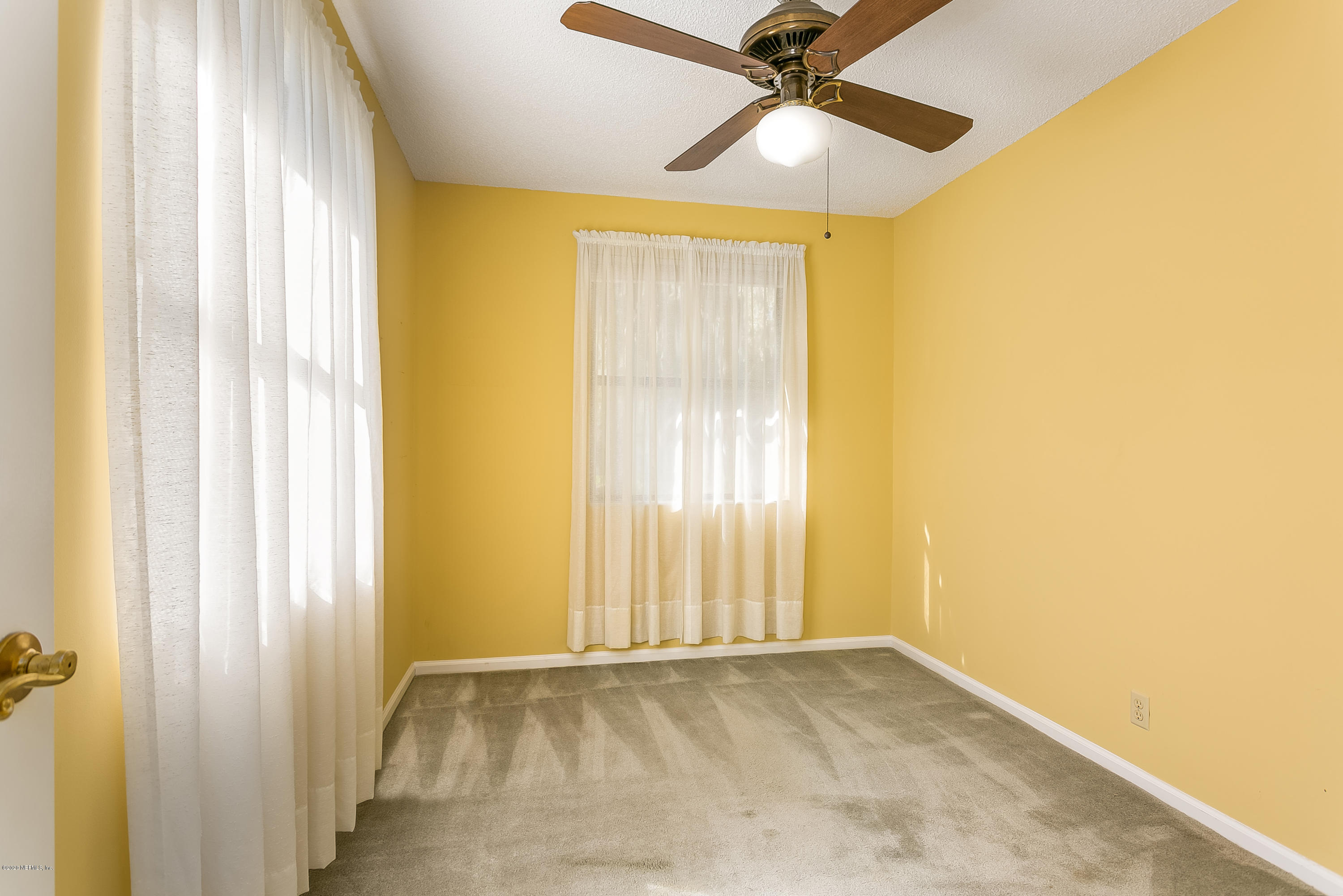 4239 Magnolia Road Orange Park, FL 32065 - Photo 29 of 40 a view of a big room with a windows and ceiling fan