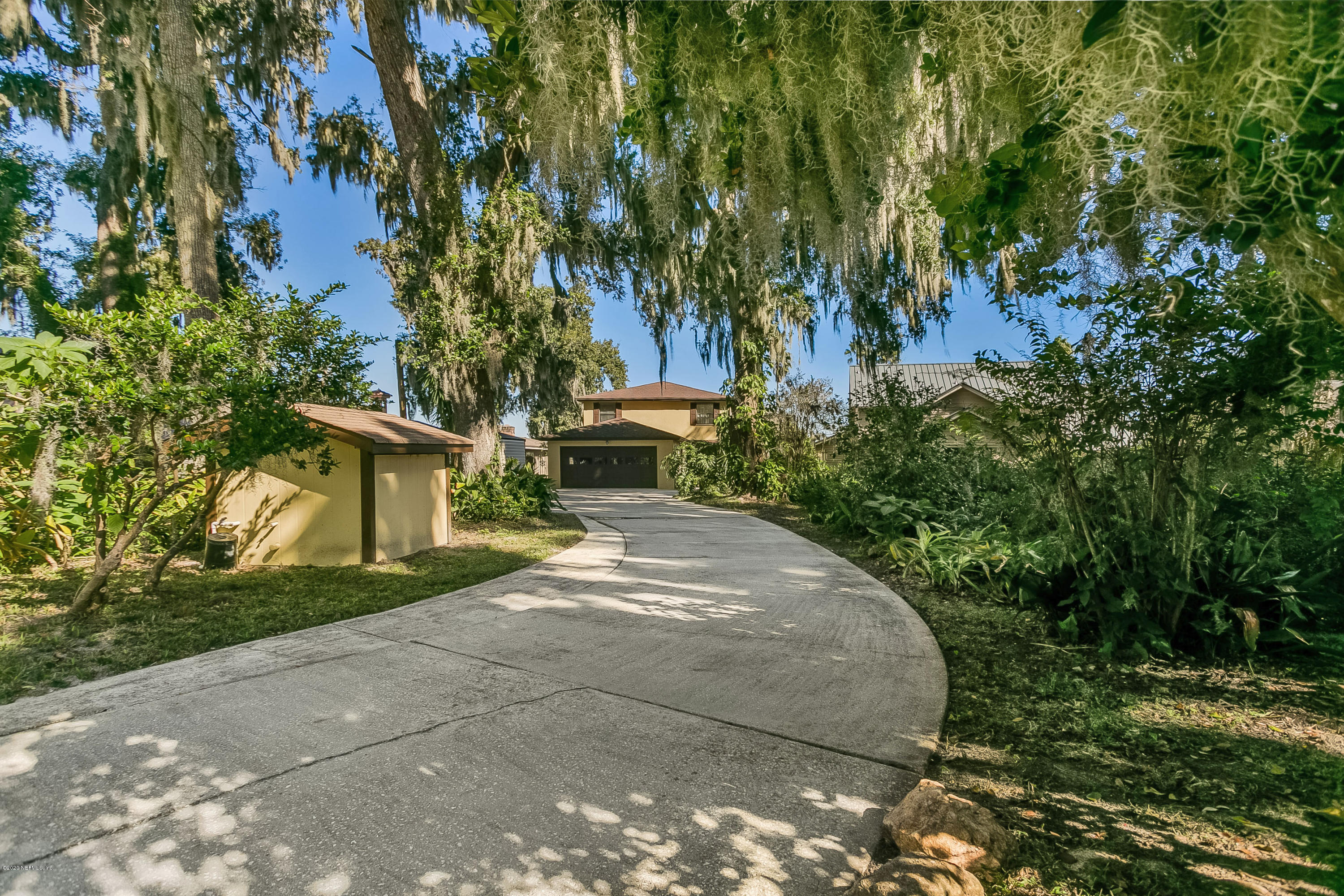 4239 Magnolia Road Orange Park, FL 32065 - Photo 34 of 40 a front view of a house with a yard and trees