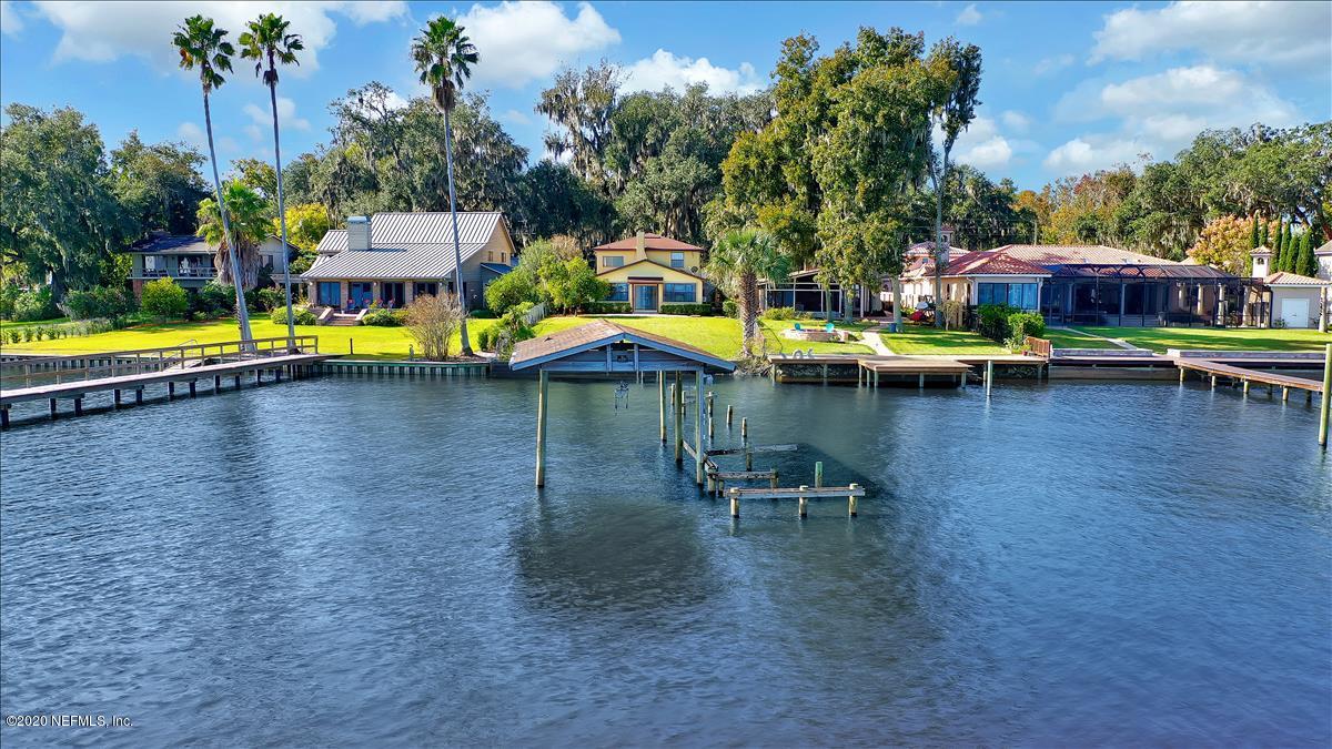 4239 Magnolia Road Orange Park, FL 32065 - Photo 40 of 40 a swimming pool with outdoor seating and yard