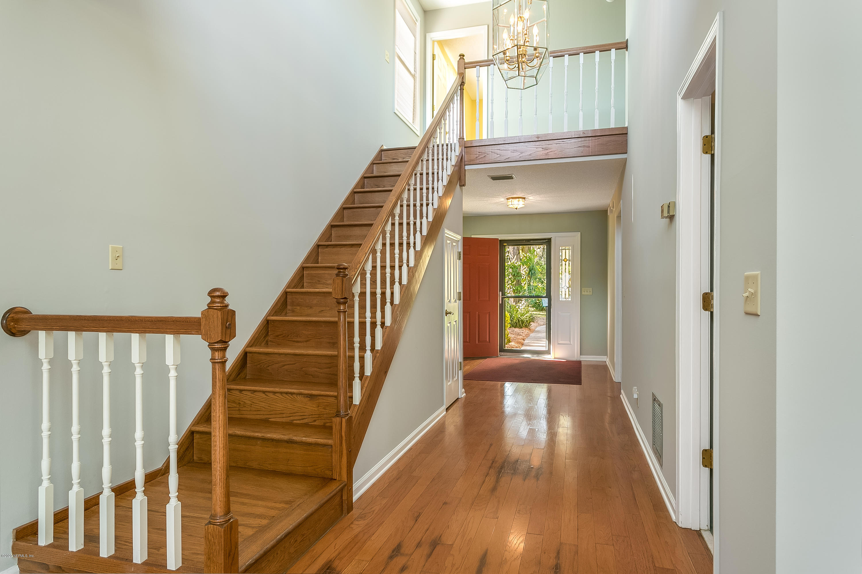 4239 Magnolia Road Orange Park, FL 32065 - Photo 4 of 40 a view of a hallway with wooden floor and staircase