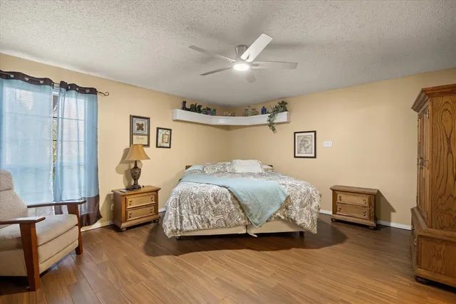 a spacious bedroom with a bed couch and a window