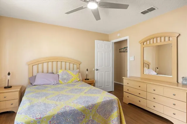 a bedroom with a bed and a mirror on dresser