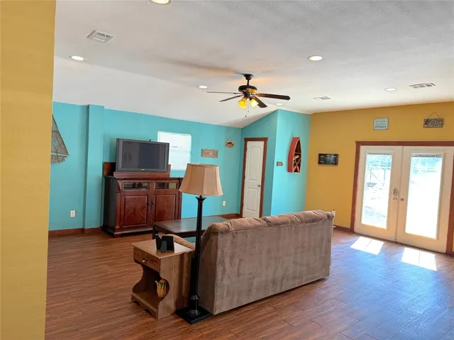 a living room with furniture and a wooden floor