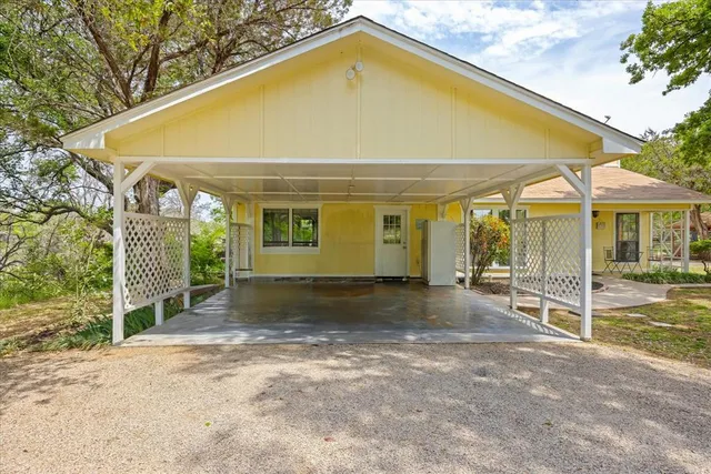 a view of a house with a backyard and floor to ceiling window