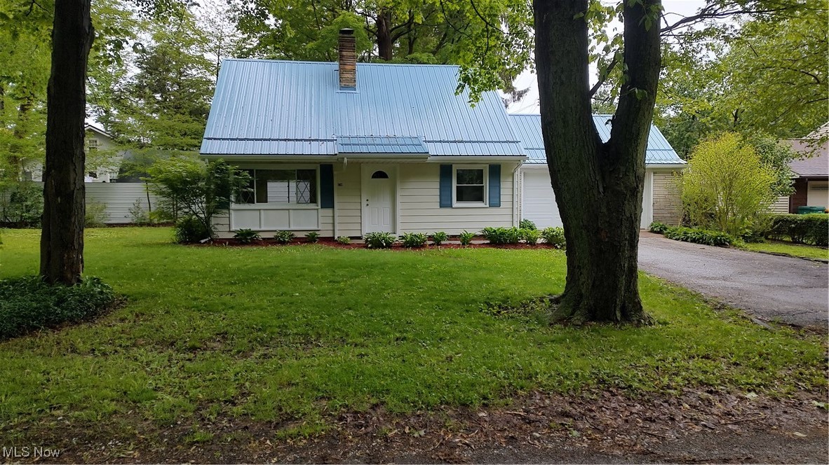 1750 Trinity Road Madison, OH 44057 - Photo 3 of 28 View of front of property with a standing seam roof, a chimney, a front lawn, and metal roof