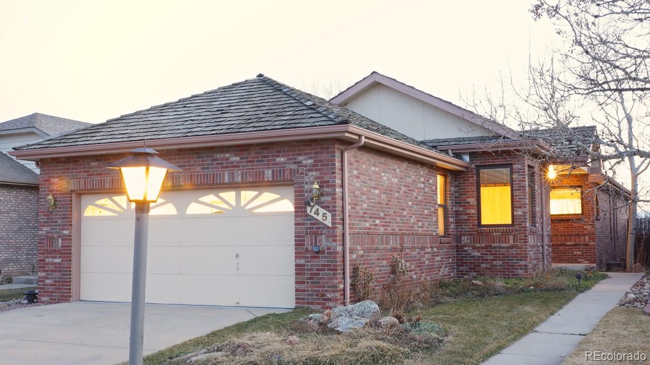 745 Wade Road Longmont, CO 80503 - Photo 1 of 1 a front view of a house with a yard